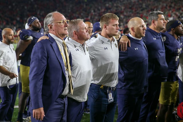 Director of athletics Jack Swarbrick and head coach Brian Kelly unite during the Alma Mater after the heartbreaking 20-19 loss to Georgia.