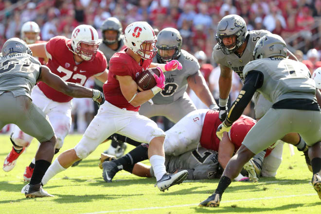 Christian McCaffrey tries to elude a swarm of Colorado defenders during Stanford's 10-5 loss Saturday.