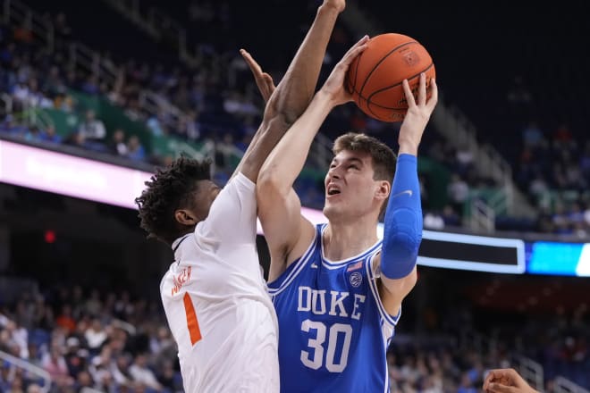 Duke's Kyle Filipowski, right, goes up against Miami's Anthony Walker during Friday night's game in the ACC tournament. 