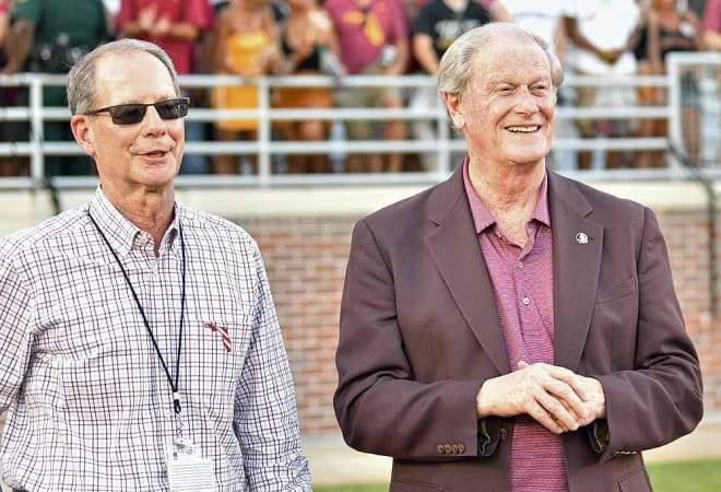 David Coburn (left) and John Thrasher (right) stand on the sideline during a Florida State football game.