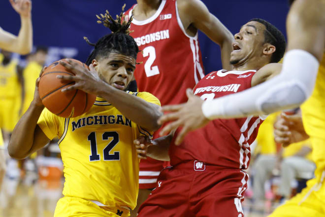 Michigan point guard Mike Smith led a balanced scoring attack against a reeling Wisconsin team.