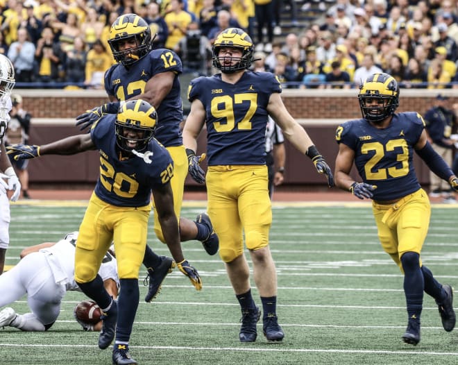 Michigan Wolverines football safety Brad Hawkins (No. 20), linebacker Josh Ross (No. 12) and defensive end Aidan Hutchinson (No. 97) all contributed to the team's 49-3 win over the Western Michigan Broncos in 2018.