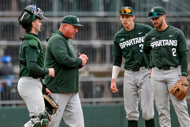 Michigan State's head baseball coach Jake Boss Jr. talks to his team during a pitching change.  