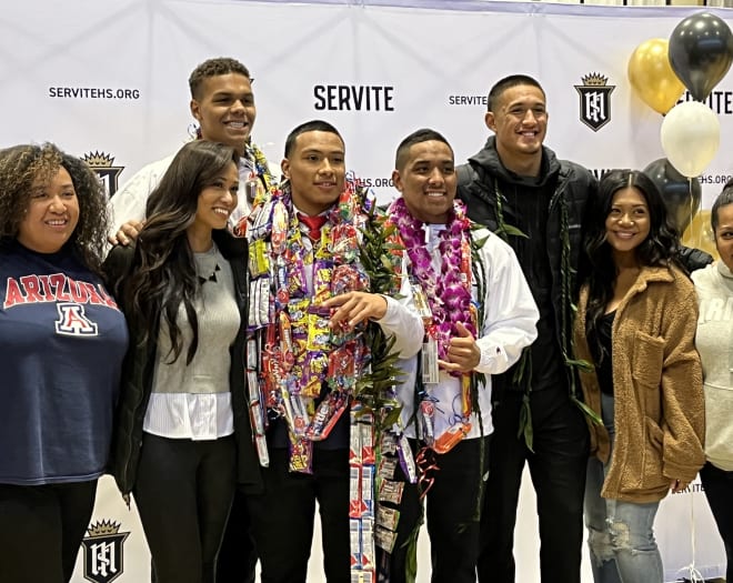 Five-star WR Tetairoa McMillan (right) poses with Arizona signees Noah Fifita, Jacob Manu and Keyan Burnett at his school's Signing Day ceremony.