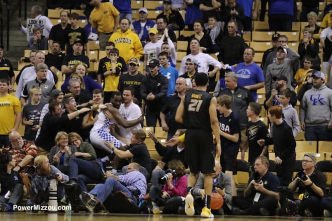 A Kentucky player flies into the crowd