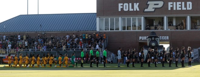 Purdue Boilermakers and University of Southern California Trojans players look towards the flag during the NCAA women s soccer game, Thursday, Aug. 18, 2022, at Folk Field in West Lafayette, Ind.