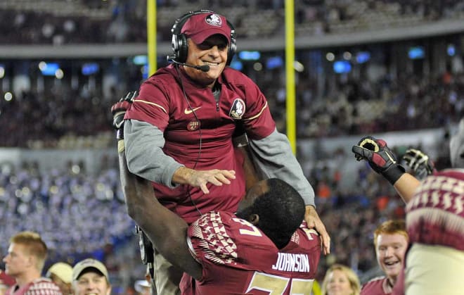 Roderick Johnson lifts up offensive line coach Rick Trickett in celebration.