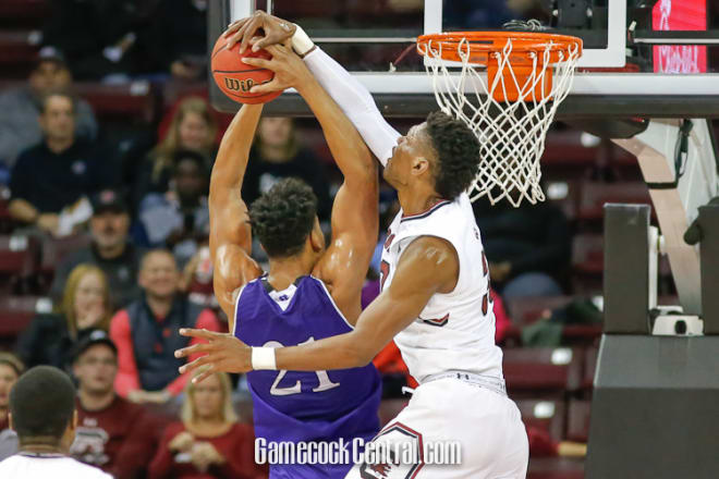 The Gamecocks' Chris Silva (right) blocks a shot during Sunday night's 81-49 victory over Holy Cross. USC, 2-0, hosts Monmouth Tuesday night at CLA.