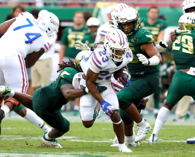 Sept. 11, 2021; Tampa, Florida; Florida Gators running back Demarkcus Bowman (23) runs through a couple of South Florida Bulls defenders at Raymond James Stadium.