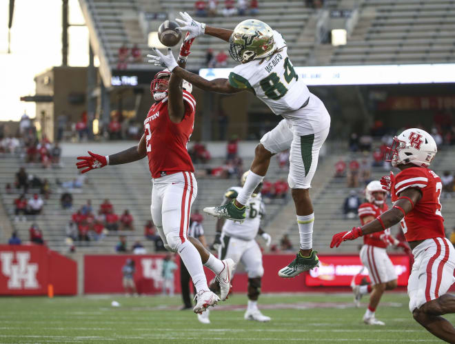 Nov 14, 2020; Houston, Texas; South Florida Bulls wide receiver Xavier Weaver (84) makes a reception as Houston Cougars safety Deontay Anderson (2) defends at TDECU Stadium.