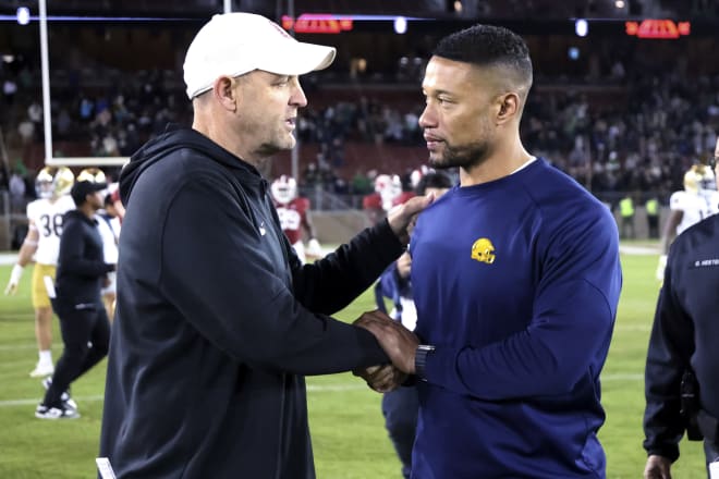 Notre Dame coach Marcus Freeman (right) chats with Stanford coach Troy Taylor after Saturday's 56-23 Irish win at Stanford.