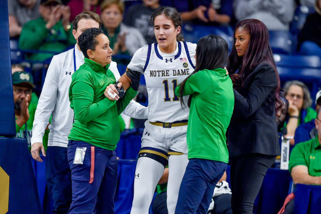 Notre Dame guard Sonia Citron (11) gets help leaving the court after suffering a leg injury during ND's 110-52 rout of Northwestern on Wednesday night.