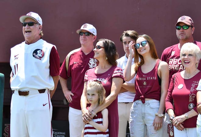 Mike Martin Jr. (second from left) watches a video tribute to his dad during a home game earlier this season. 