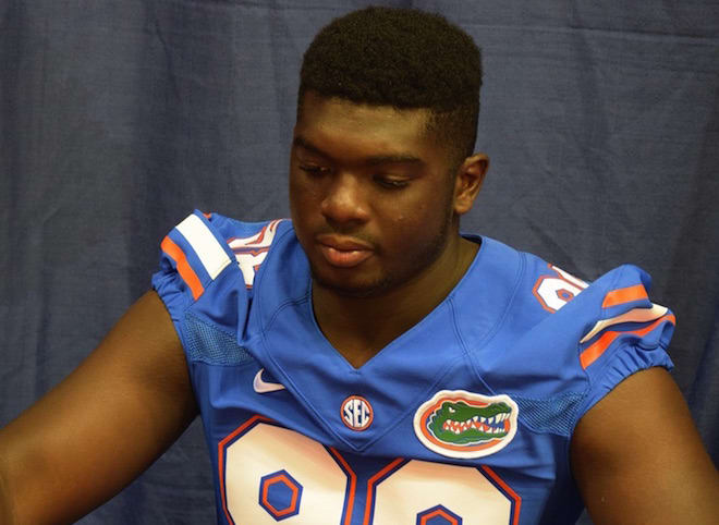 Freshman defensive lineman Luke Ancrum signs an autograph during UF's fan day last August.