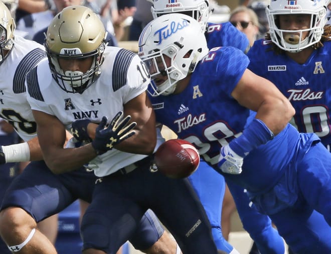 Tulsa linebacker Craig Suits forces a fumble in the first quarter against Navy.