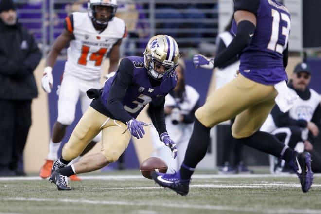 Washington Huskies defensive back Elijah Molden (3) jumps on the ball after it hit an Oregon State Beavers player on a punt for a turnover during the third quarter at Husky Stadium. Photo Credit: Jennifer Buchanan-USA TODAY Sports