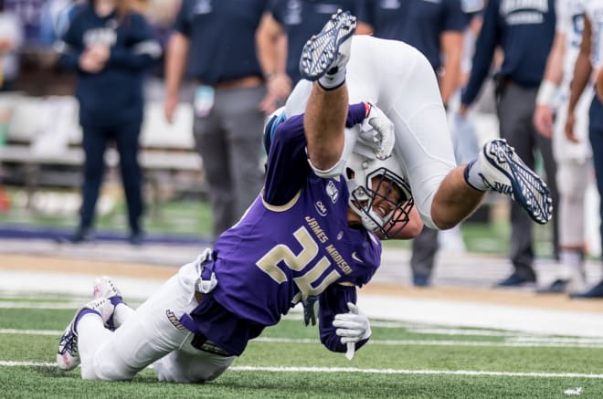 James Madison safety D'Angelo Amos (24) tackles Villanova tight end Todd Summers during the Dukes' win over the Wildcats in October.