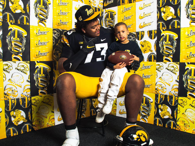 2025 four-star OT Nick Brooks pictured with the youngest of his 17 siblings on a vist at Iowa. 