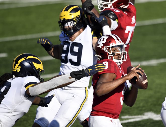Indiana Hoosiers quarterback Michael Penix eludes Michigan Wolverines Football pass rush