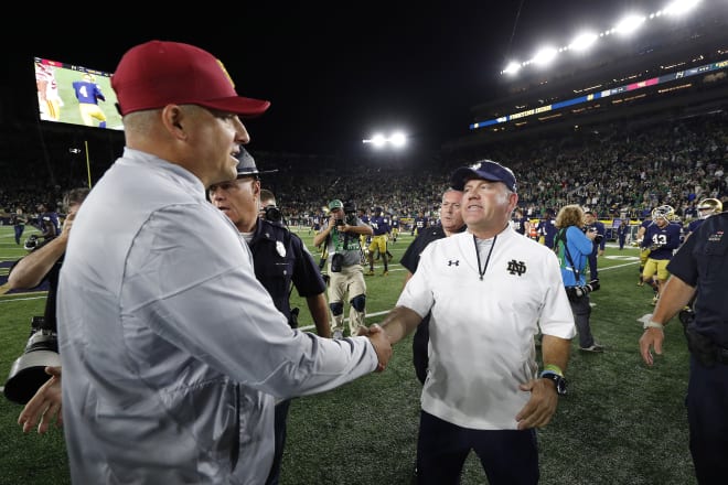 USC coach Clay Helton and Notre Dame coach Brian Kelly lead their teams into a pivotal showdown Saturday night in South Bend, Ind.