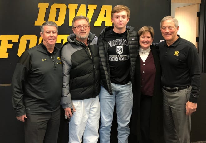 Quarterback Spencer Petras and family with Iowa coaches Ken O'Keefe and Kirk Ferentz.
