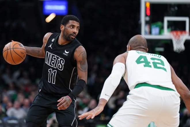Former Brooklyn Nets guard Kyrie Irving (11) returns the ball against Boston Celtics center Al Horford (42) in the second half at TD Garden. Mandatory Credit: David Butler II-USA TODAY Sports