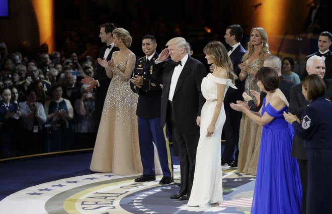President Donald Trump gestures to the crowd at one of the inaugural balls Friday night in Washington, D.C.