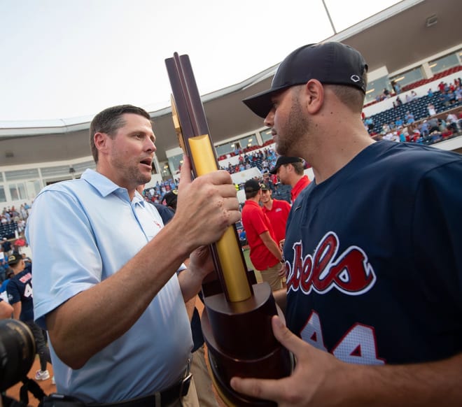 Ole Miss athletic director Keith Carter, left, hands off the championship trophy to Dylan DeLucia after a celebration of the National Champion Rebel baseball team, winners of the College World Series,... Barbara Gauntt/Clarion Ledger-USA TODAY NETWORK