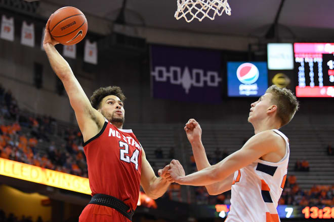 NC State Wolfpack basketball guard Devon Daniels goes up for a dunk at Syracuse.