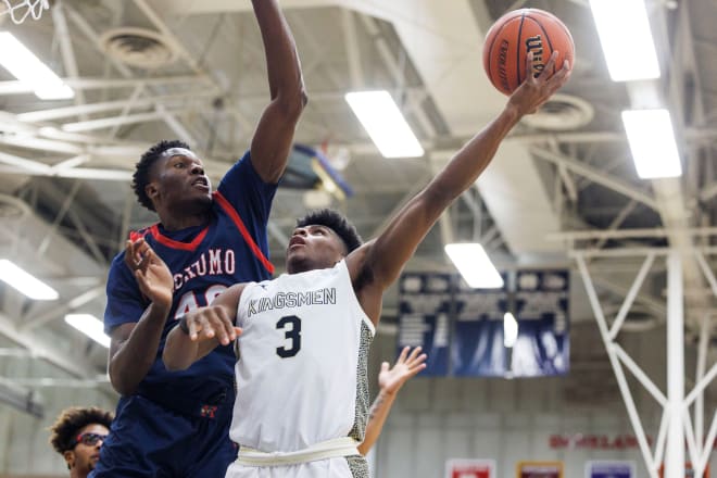 Future Notre Dame point guard Markus Burton challenges Kokomo 6-9 center Flory Bidunga — the nation's No. 2 prospect in the 2024 class — in a recent Indiana state tournament playoff game.