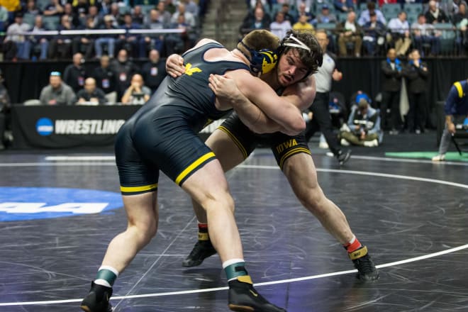 Iowa's Tony Cassioppi locks up with Michigan's Mason Parris in the 285 lb semifinals. 