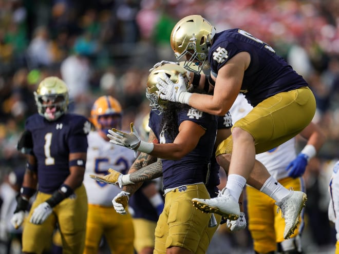 Notre Dame defensive tackle Rylie Mills, right, celebrates with linebacker Marist Liufau.