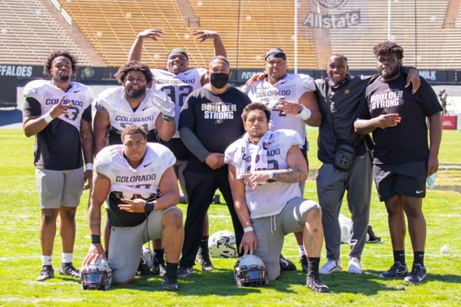 Aziz Shittu and Chris Wilson pose with Colorado's defensive linemen following completion of the 2021 spring showcase at Folsom Field