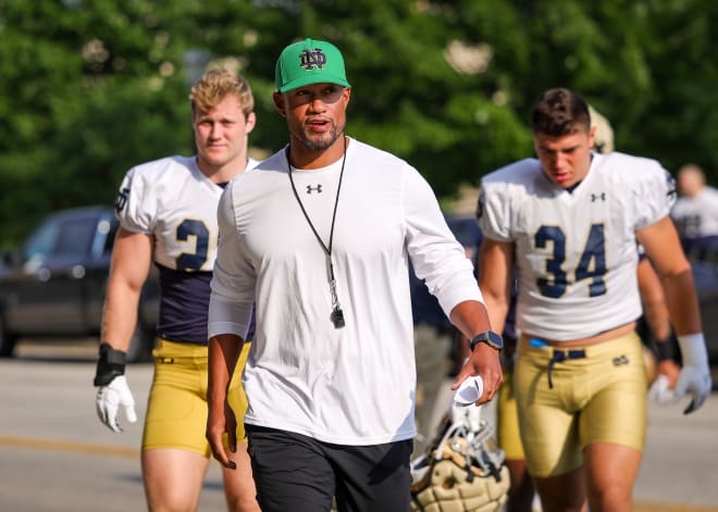 Notre Dame coach Marcus Freeman (center) and the Irish find themselves ranked 13th in the preseason coaches poll.