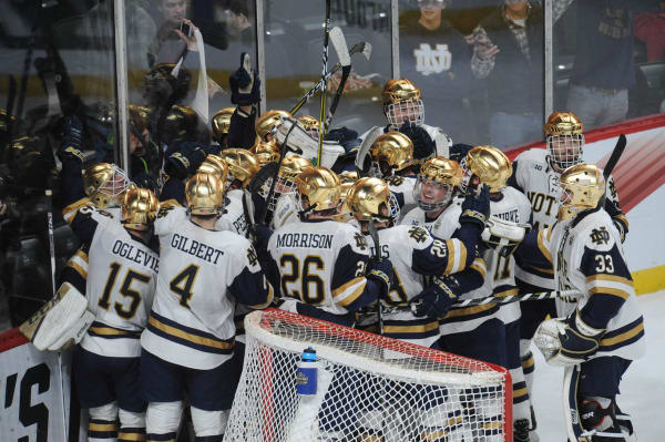 Notre Dame players celebrate after defeating Michigan 4-3 Thursday in the Frozen Four semifinal.