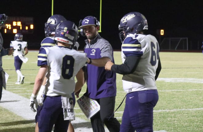 Kellis head coach Ben Kullos talks to cornerback/punter/kicker Cory Wood during a road game at Canyon View last season.  (Photo Courtesy of Ben Kullos)