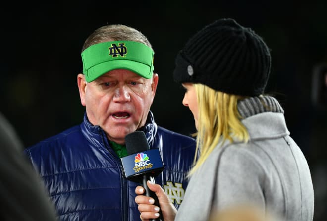 Notre Dame Head Coach Brian Kelly speaking to a reporter after his team's victory against rival USC (Andris Visockis)