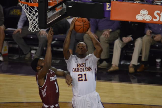 B.J Tyson drives by Temple's Josh Brown in ECU's 64-61 victory over the Owls Wednesday night.