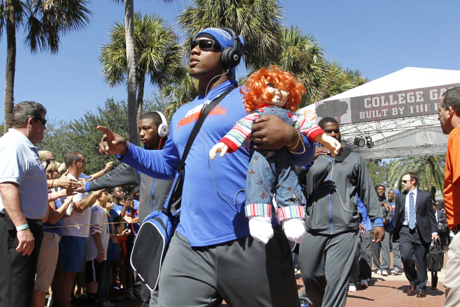 Dominique Easley going through at Gator Walk with his Chucky doll.