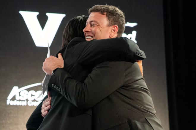 Mark Byington, right, hugs athletic director Candice Lee, left, as he is introduced as Vanderbilt’s new men’s basketball coach at Memorial Gym in Nashville