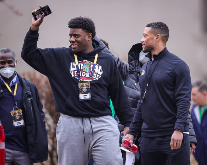 Five-star prospect Justin Scott (left) walks with Irish head coach Marcus Freeman during a recruiting visit to Notre Dame back in late March.