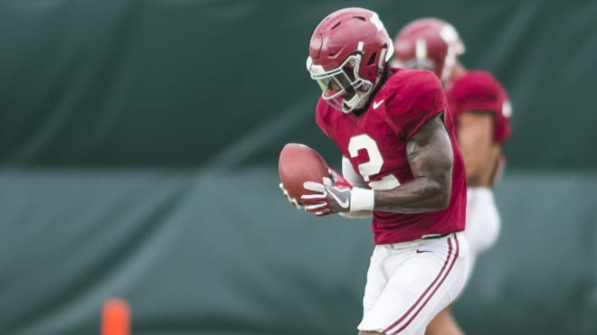 Tony Brown catches a football during spring workouts | Photo Laura Chramer 