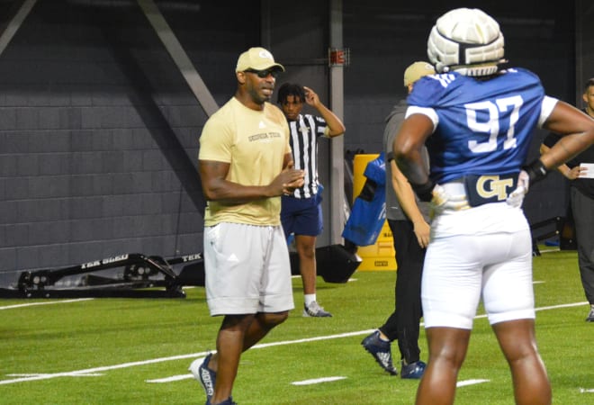 DL coach Marco Coleman works with Eddie Kelly during practice 