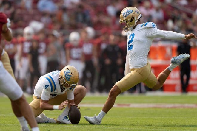 Sep 25, 2021; Stanford, California, USA; UCLA Bruins quarterback Ethan Garbers (4) holds the ball for place kicker Nicholas Barr-Mira (2) during the first quarter against the Stanford Cardinal at Stanford Stadium.