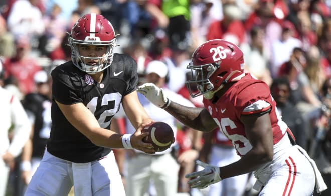 Alabama quarterback Dylan Lonergan (12) hands the ball off to running back Jam Miller (26) at Bryant-Denny Stadium. Photo | Gary Cosby-USA TODAY Sports