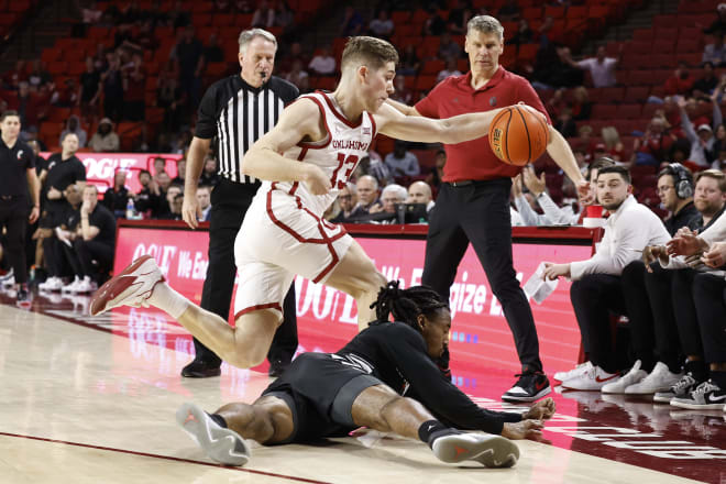 Oklahoma Sooners guard Maks Klanjscek (13) reaches for a loose ball over Cincinnati Bearcats guard Day Day Thomas