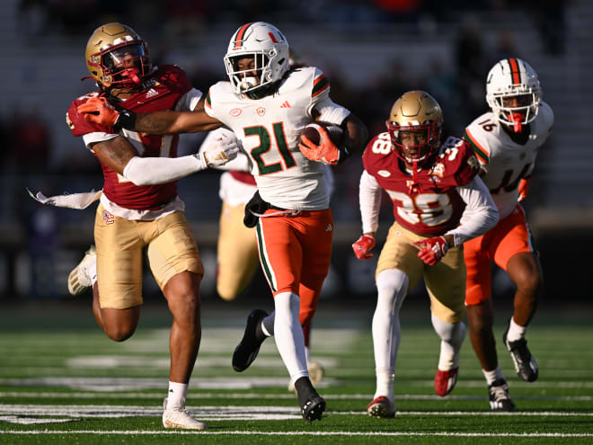 Miami Hurricanes running back Henry Parrish Jr. (21) runs against Boston College Eagles linebacker Daveon Crouch (27) during the second half at Alumni Stadium. Mandatory Credit: Brian Fluharty-USA TODAY Sports
