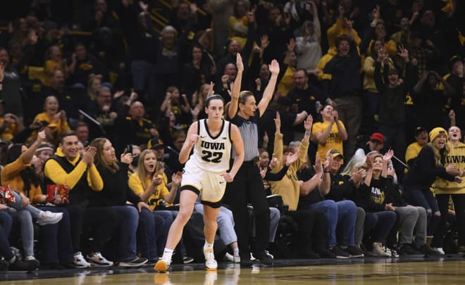 Iowa guard Caitlin Clark (22) celebrates a 3-point basket against Indiana during the first half of an NCAA college basketball game Saturday, Jan. 13, 2024, in Iowa City, Iowa. (AP Photo/Cliff Jette)