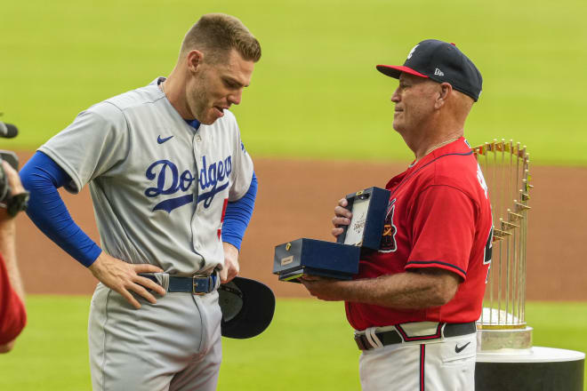Los Angeles Dodgers first baseman Freddie Freeman (5) reacts as he receives his World Series ring from Atlanta Braves manager Brian Snitker (43) prior to the game at Truist Park. Mandatory Credit: Dale Zanine-USA TODAY Sports
