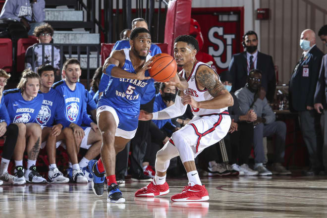Nov 23, 2021; Queens, New York, USA; St. Francis Terriers guard Larry Moreno (5) looks to make a pass as he is guarded by St. John s Red Storm guard Tareq Coburn (10) at Carnesecca Arena. 